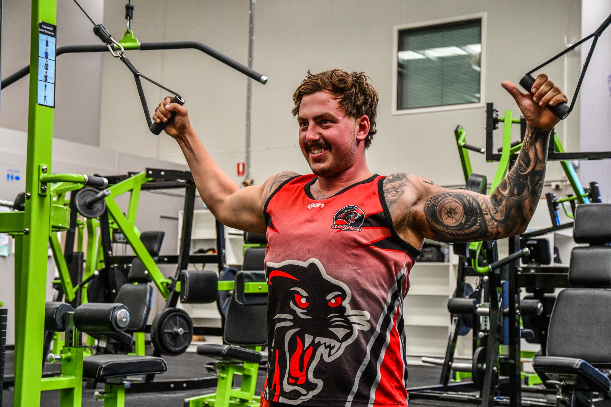A gym member smiling during a cable exercise at Lifechoice Fitness