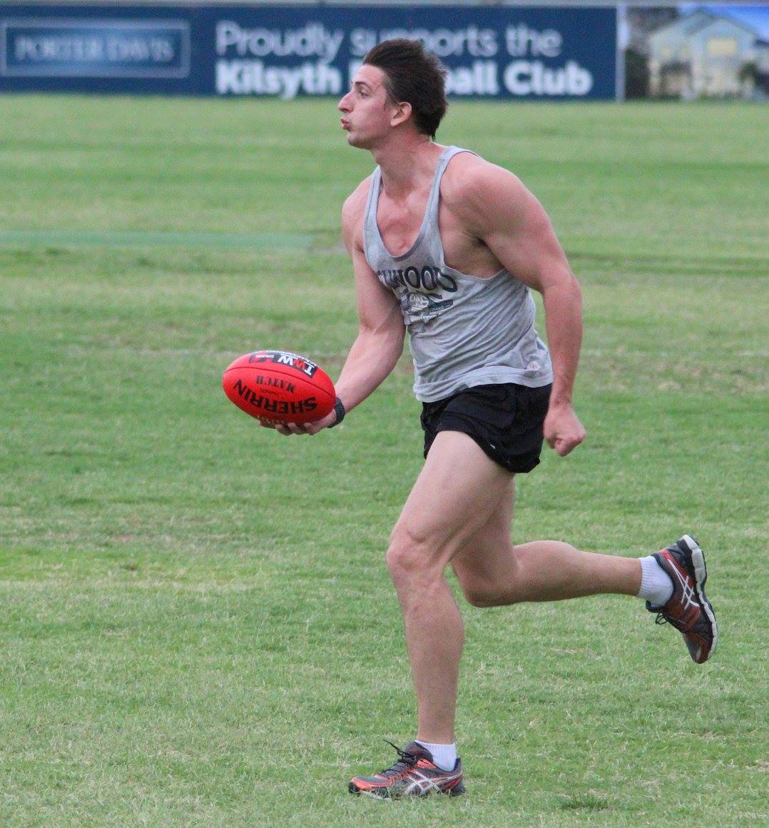 Footballer practising a kick during training
