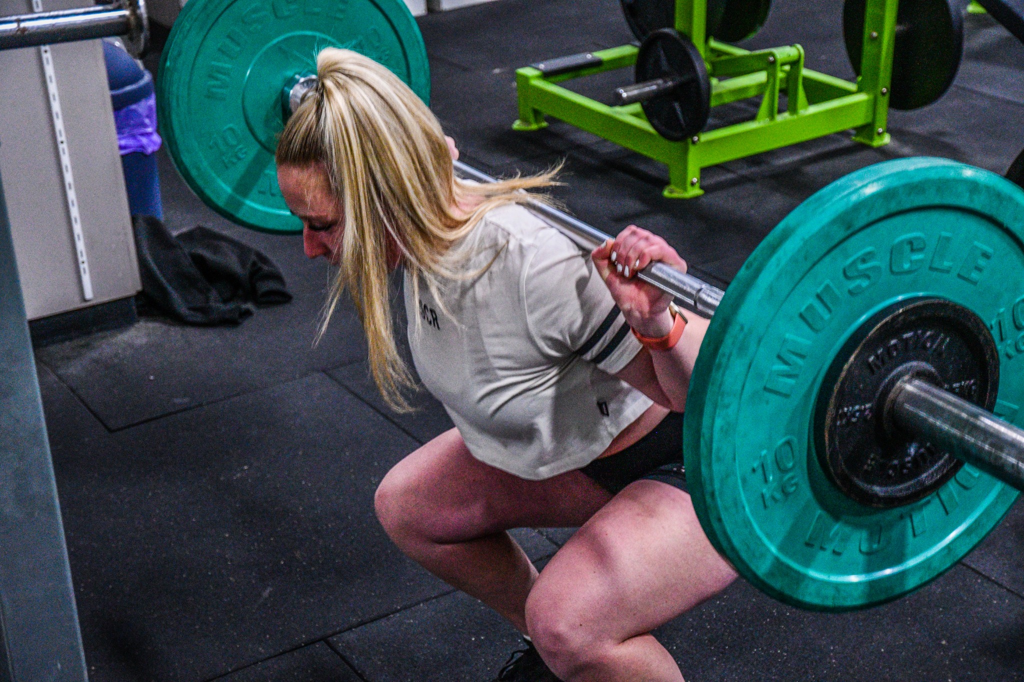 A gym member performing a barbell back squat at Lifechoice Fitness