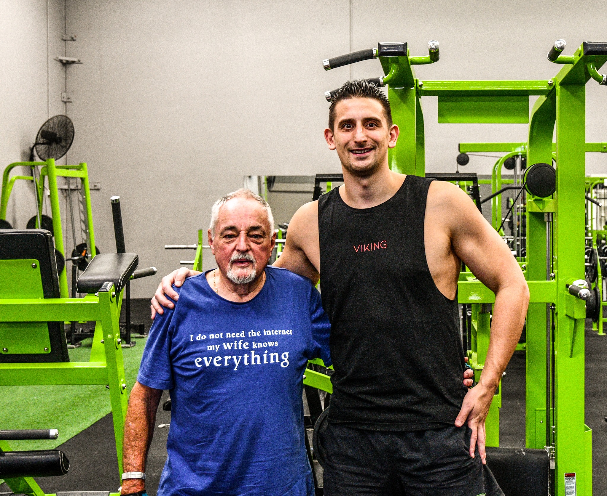 Sean Currey smiling alongside a client in the gym