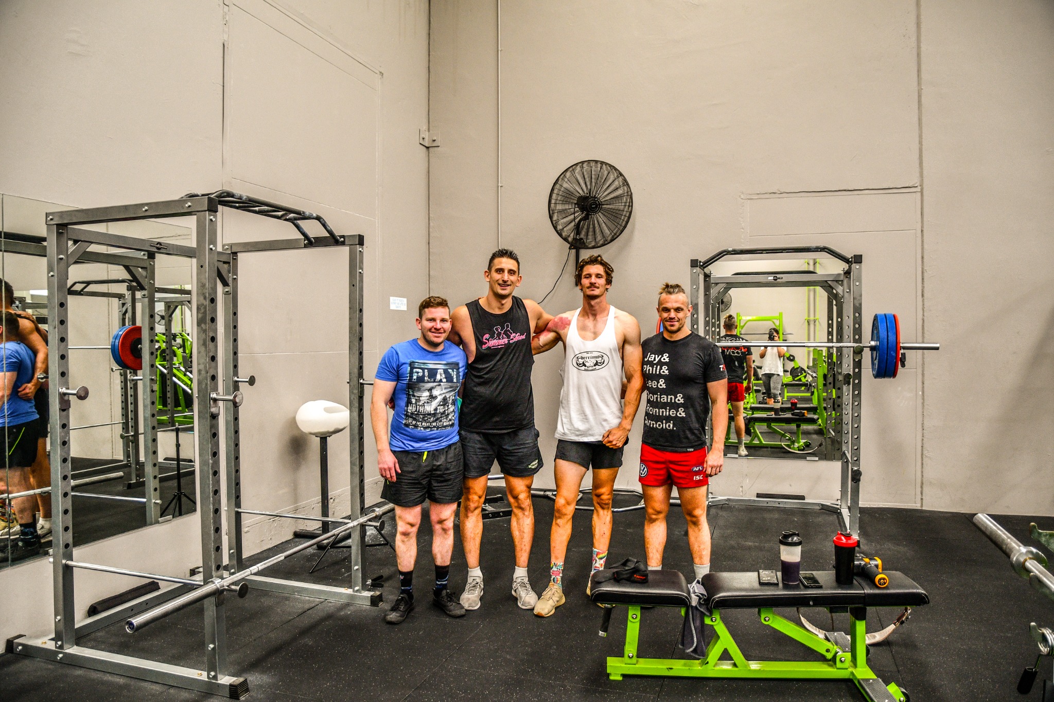 Four members of the Train With Cuz community together in the gym